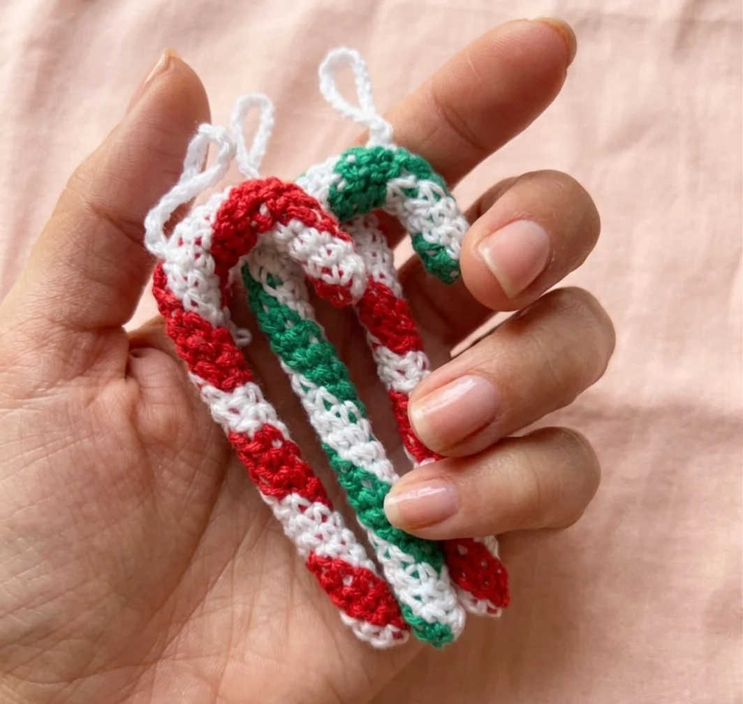 crochet candy cane pattern holding in hand