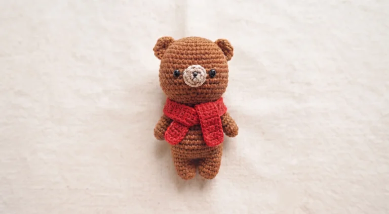 Mini brown crochet teddy bear with cute red scarf