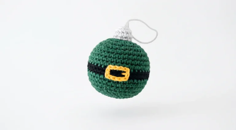 Green crochet Christmas bauble with black belt and gold buckle