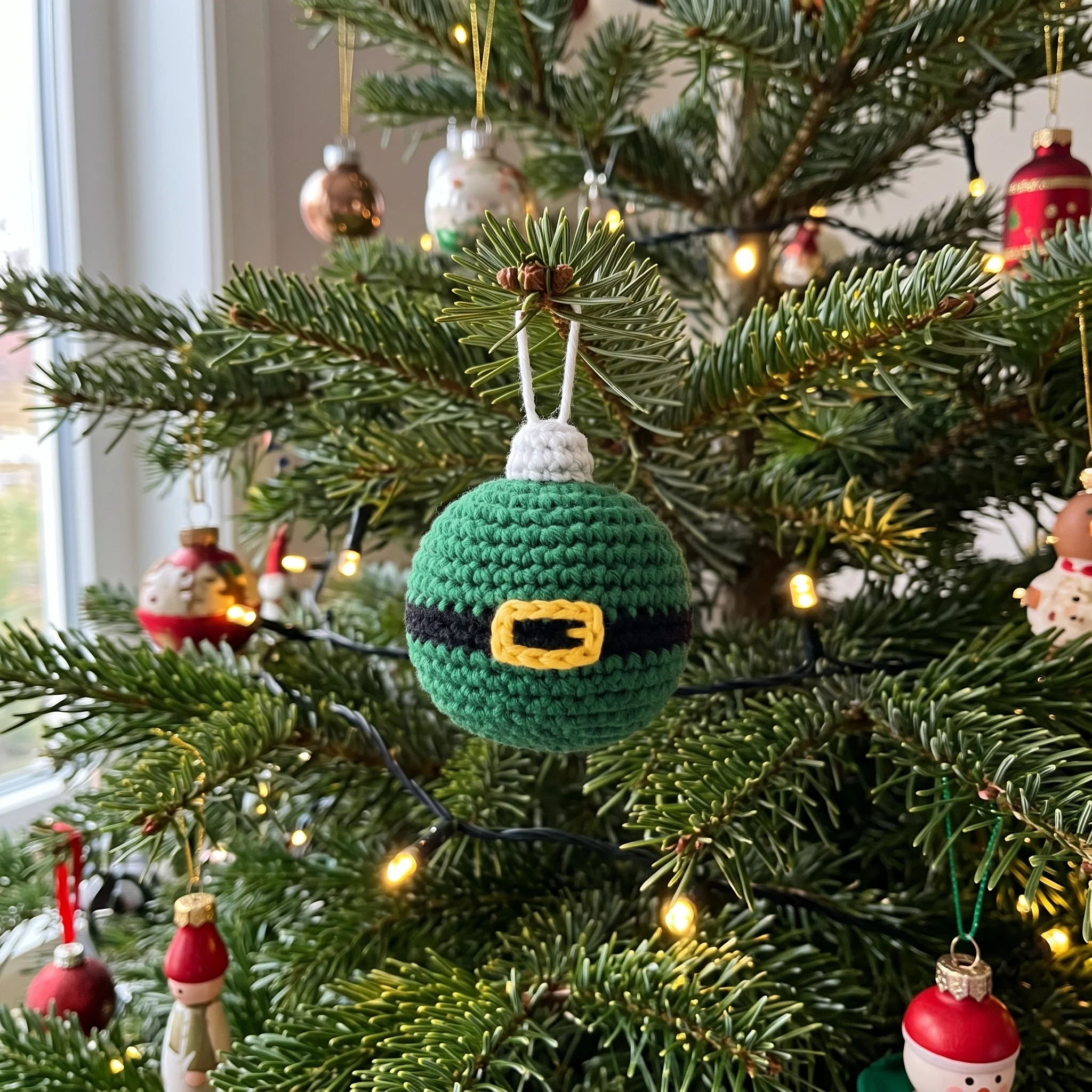 Crochet Christmas bauble hanging on a tree